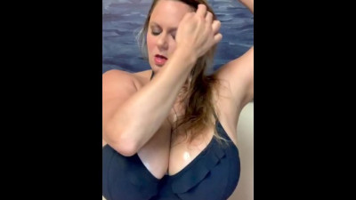 Rubbing Baby Oil on Huge Tits in Bikini Top